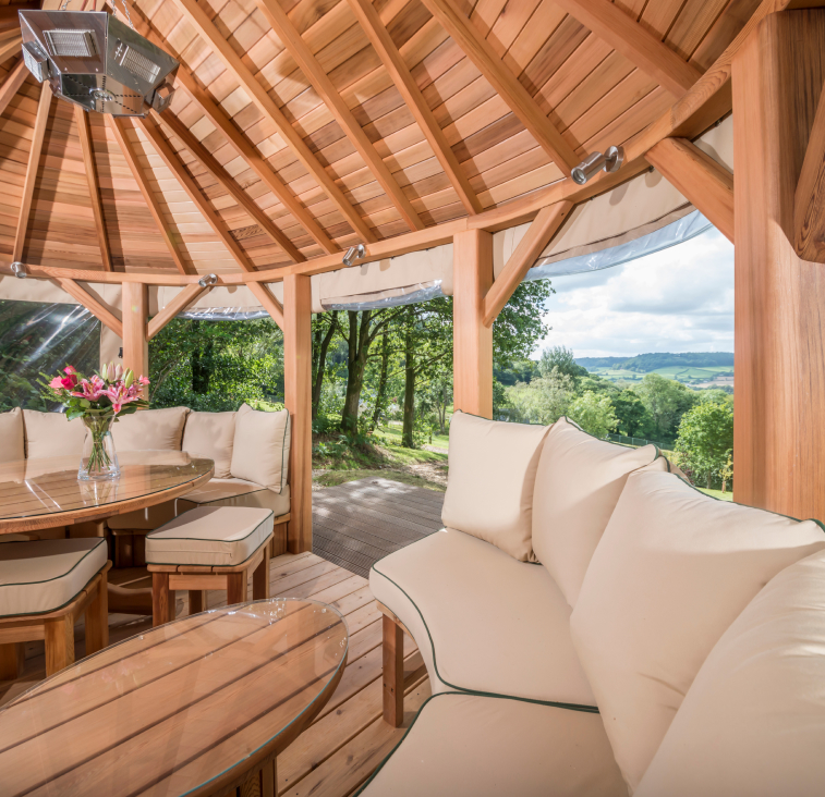 Garden room interior with view of countryside landscape