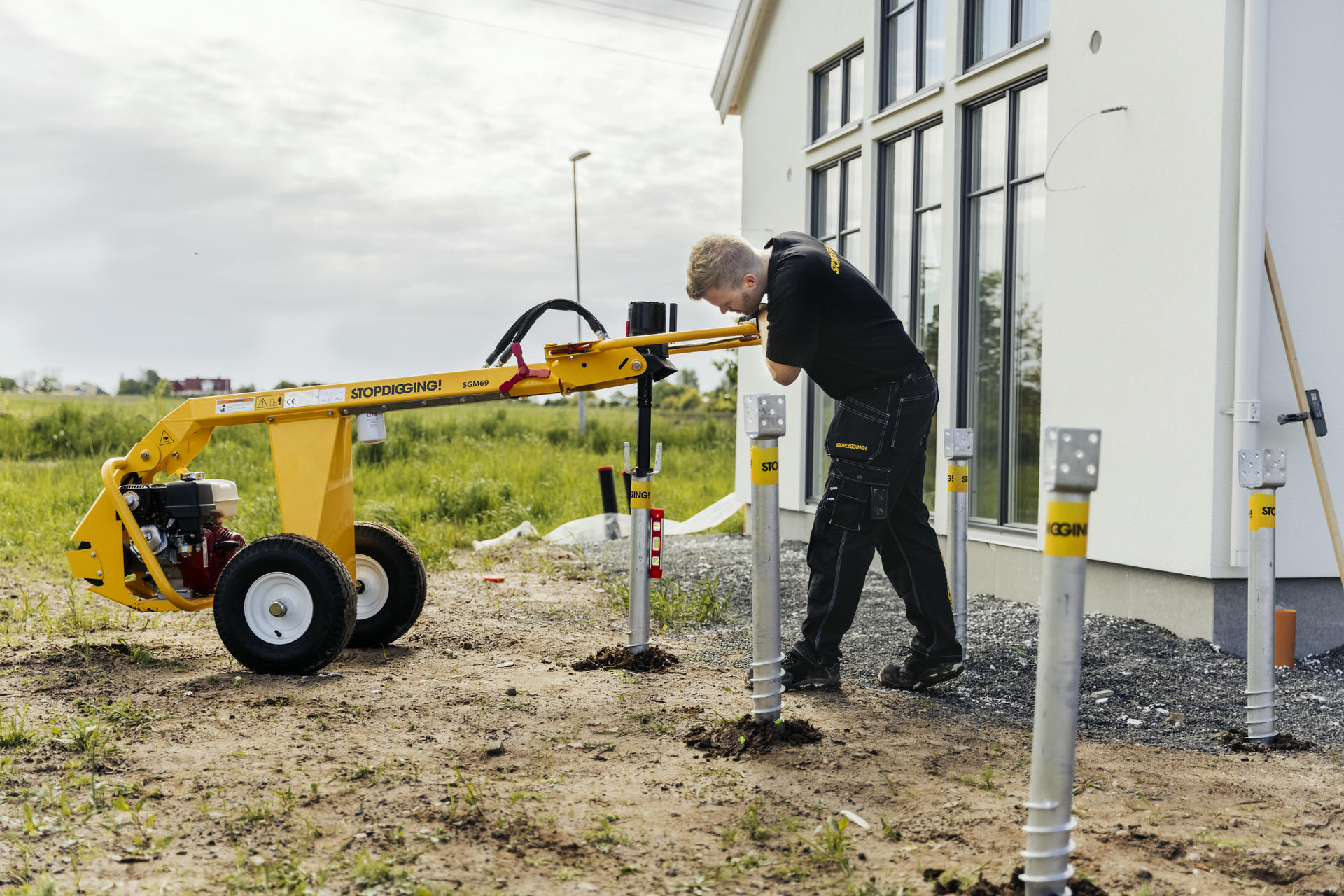 Ground screw being installed into soil